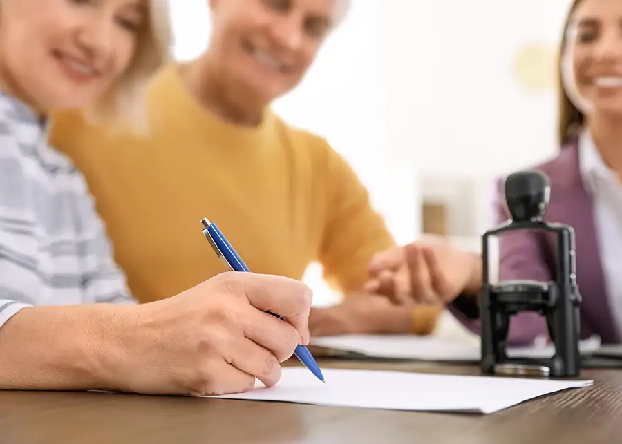Middle-Aged/Elderly couple signing contract with Health insurance agent - St. Charles, MO